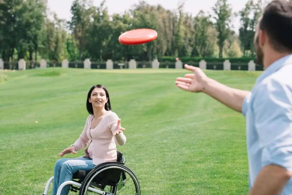 young-man-throwing-flying-disc-to-disabled-girlfri-2024-11-15-18-36-34-utc-min